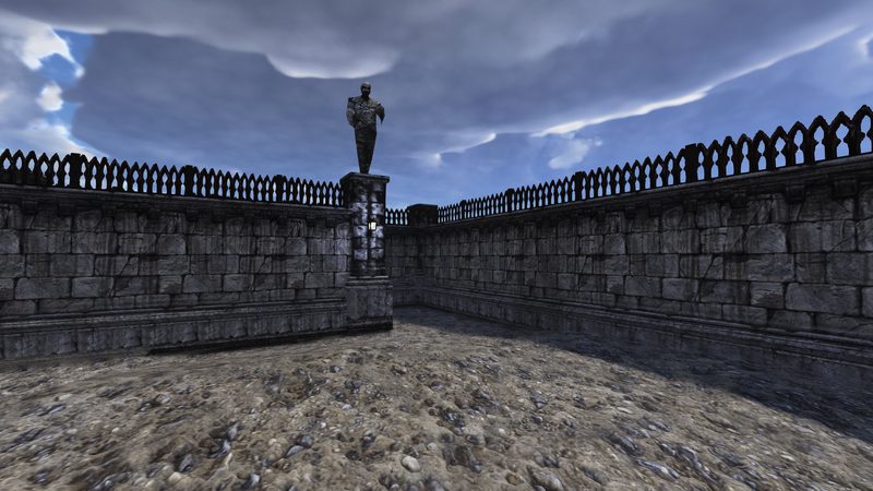 A walled stone courtyard with statues on its parapet, under a cloudy sky